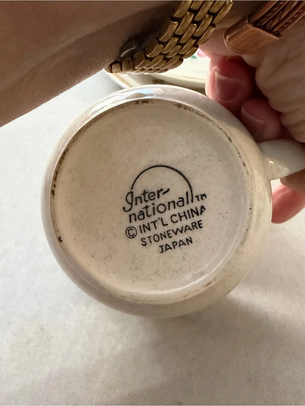 International Cream Ceramic Cup and Saucer Set with Hand-Painted Village Design